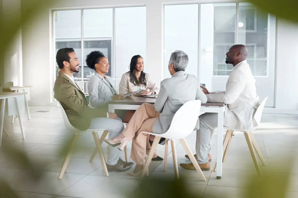 Professional business team discussing strategy during a modern office meeting, featured in a web design case study designed by Cheap Website Designer.