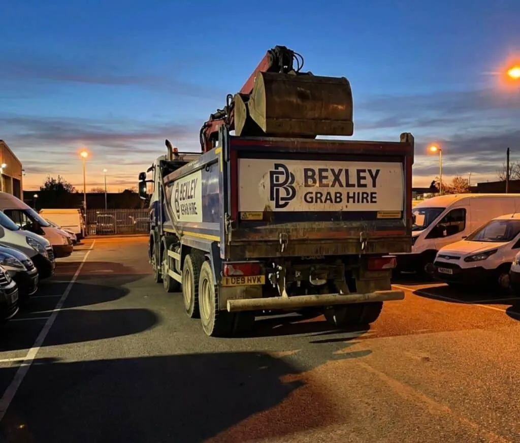 Grab hire truck parked at dusk for construction waste removal and site clearance services, featured in a web design case study designed by Cheap Website Designer.