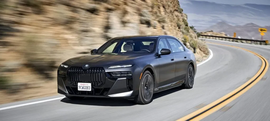 Luxury electric sedan driving on a scenic mountain road, showcasing premium performance and modern automotive design, featured in a web design case study designed by Cheap Website Designer.